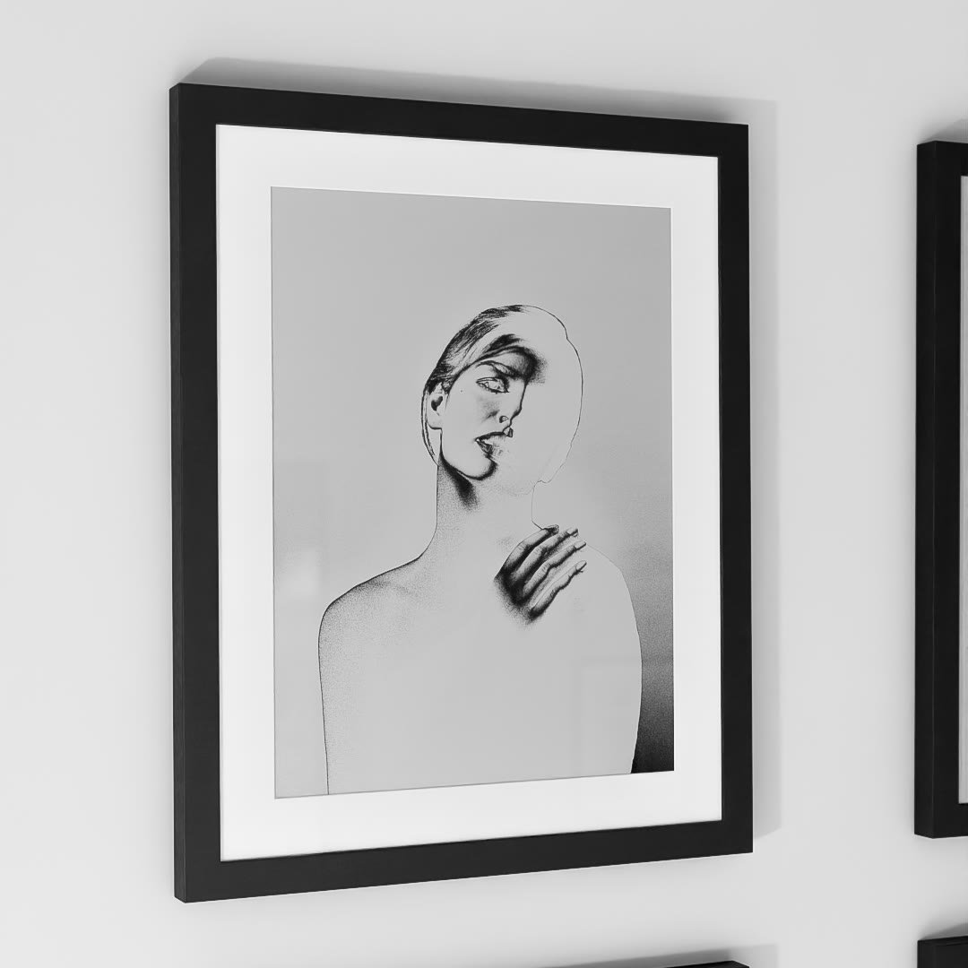 Inversion, framed with a white mat on a white wall: part of a woman's face and one hand drawn in dark lines, her shoulder and body pale and dissolving into the background